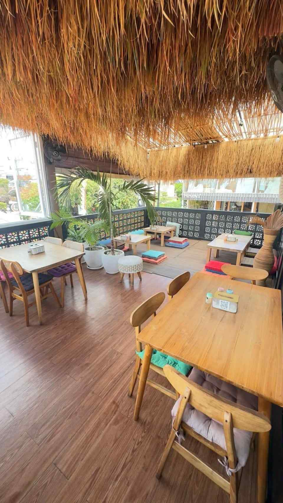 Wooden boho seating area inside Slavic Roots Cafe & Eatery in Berawa Canggu, Bali